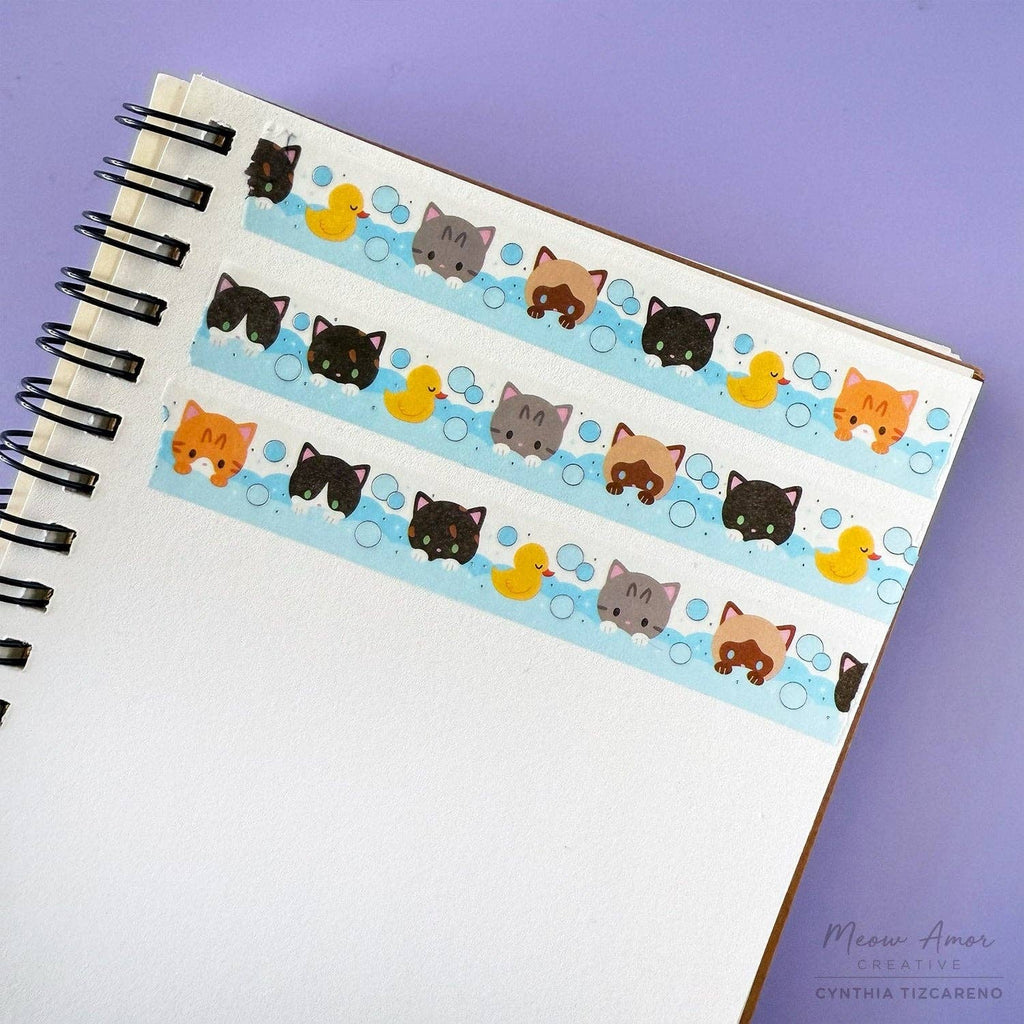 Notebook with cat and duck design washi tape on a purple background