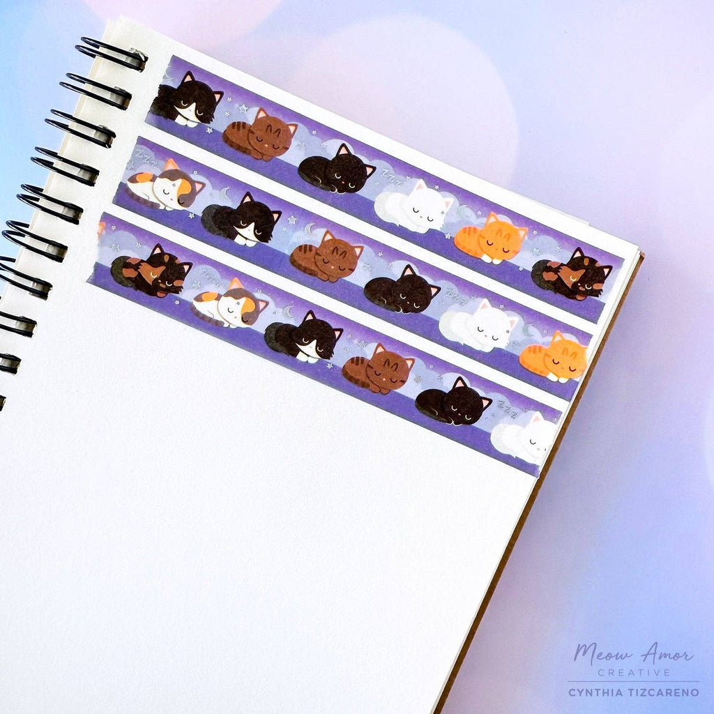 Cat-themed washi tape on a blank notebook