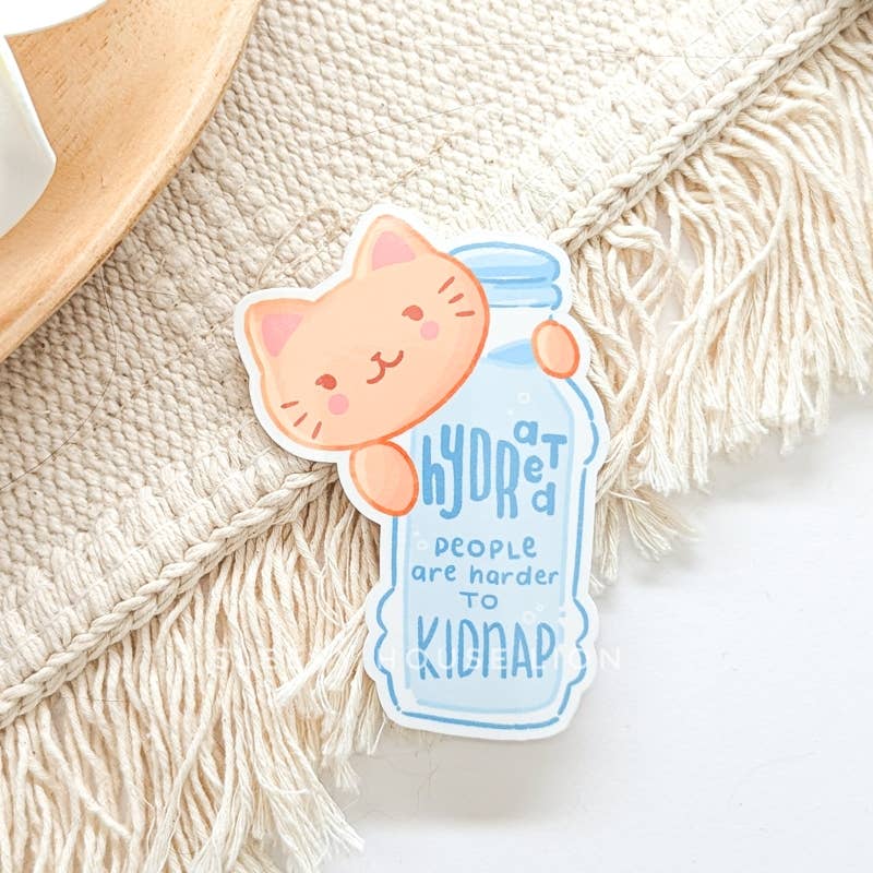 Sticker of a cat holding a jar with text on a textured surface