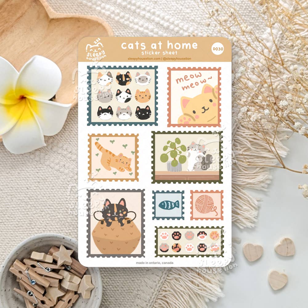 Sheet of 'cats at home' stickers with various cat illustrations on a decorative surface.