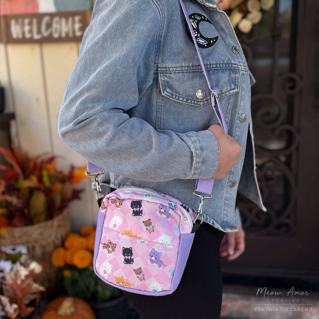Person wearing a denim jacket with a pink crossbody bag featuring cartoon characters.