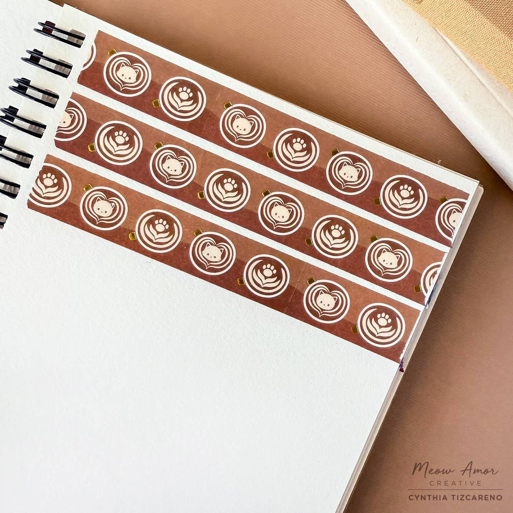 Cat and coffee-themed washi tape on a notebook