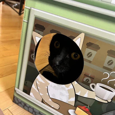 A black cat peeking out of a coffee shop-themed cardboard house