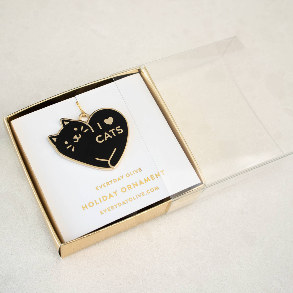 Heart-shaped ornament with 'I love cats' text in a gold box on a light background