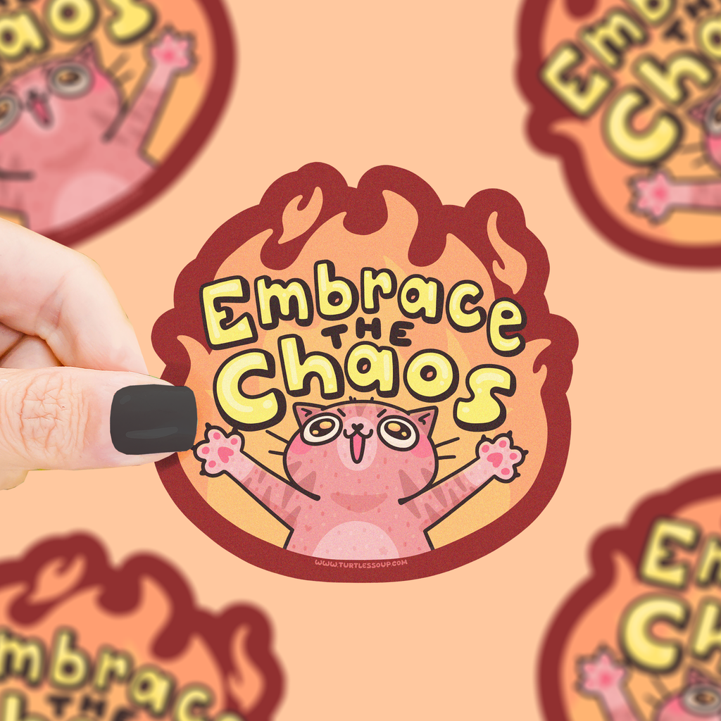Sticker with a cat illustration and 'Embrace the Chaos' text on a matching background