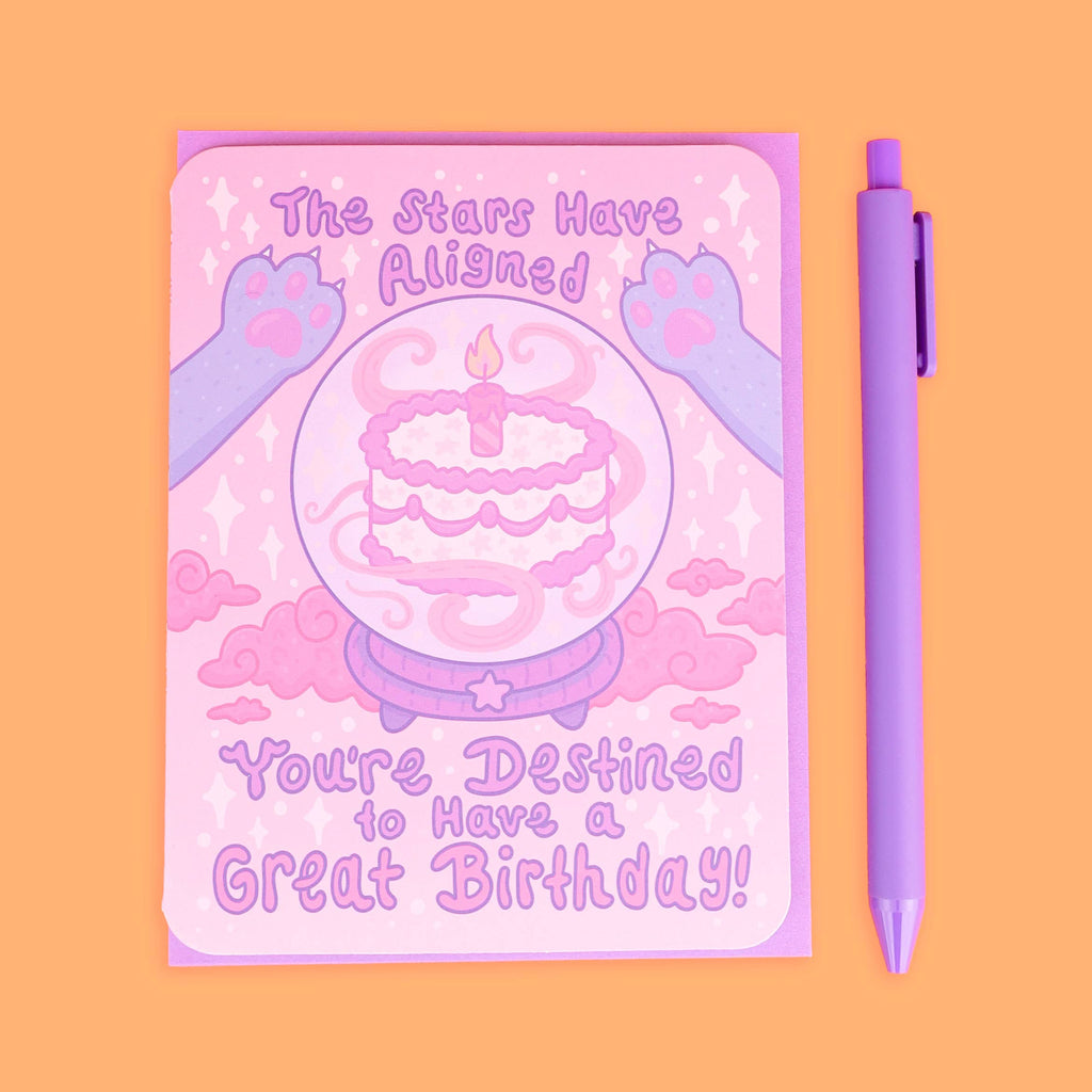 Pink birthday card with a purple pen on an orange background