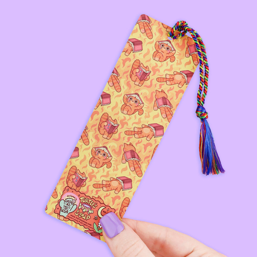 Bookmark with cartoon character pattern and colorful tassel on a purple background