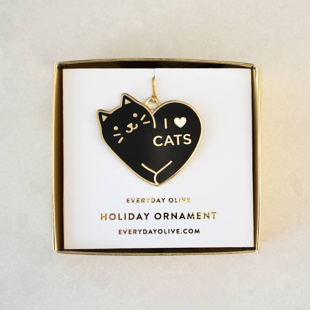 Heart-shaped ornament with 'I ❤️ CATS' text on a white card with gold border, displayed against a light gray background.