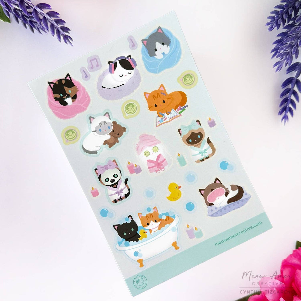 Sheet of cat-themed stickers with various designs on a light background.