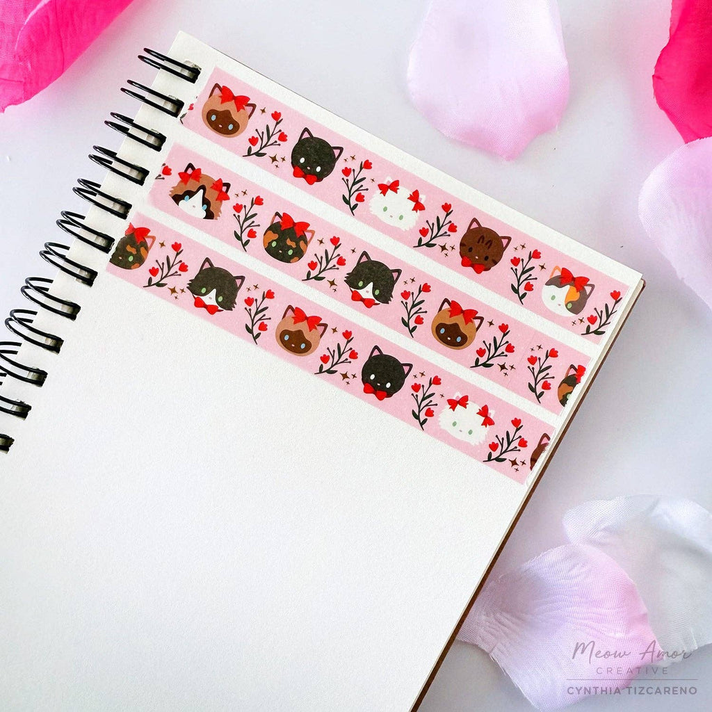 Decorative washi tape with cat designs on a notebook