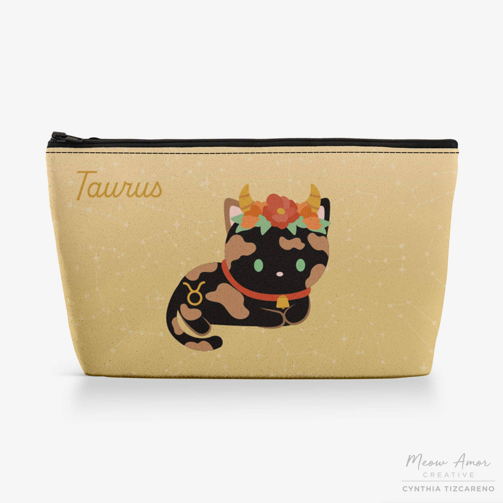 Beige pouch with a cat illustration and 'Taurus' text