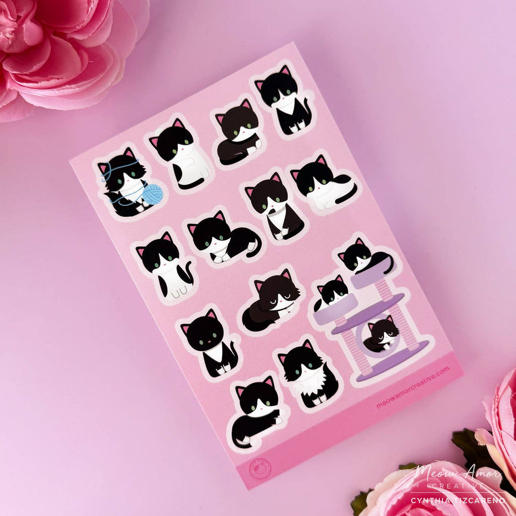 Sheet of cat-themed stickers on a pink background with floral decorations.