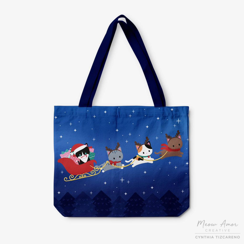 Tote bag with cartoon cats in a sleigh design on a blue background