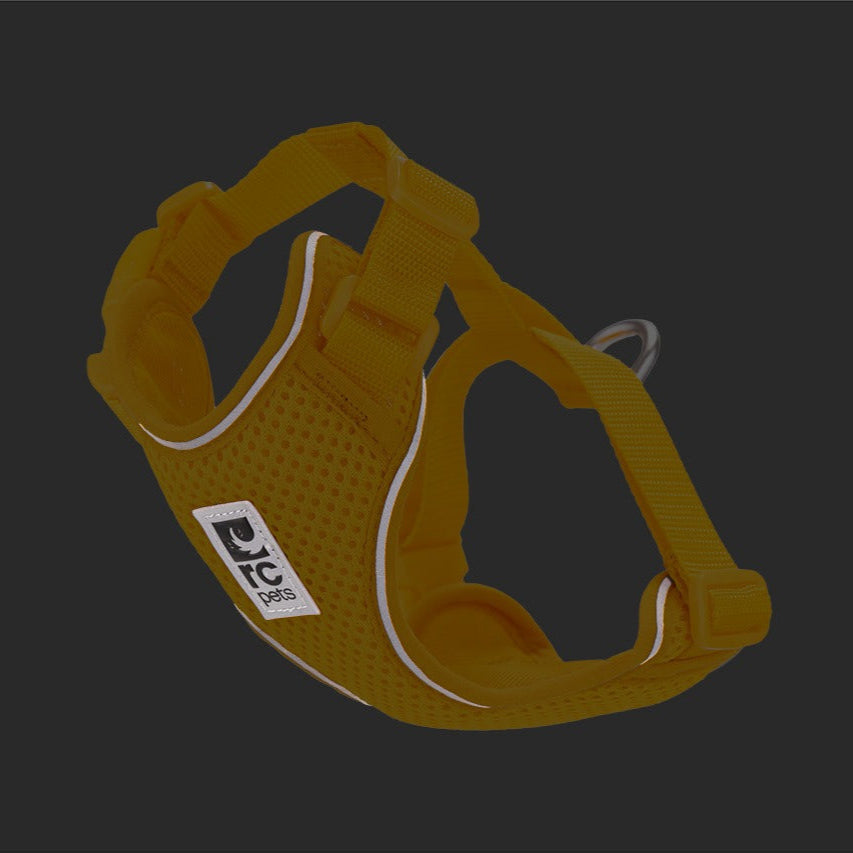 Yellow cat harness with a visible brand logo on a dark background